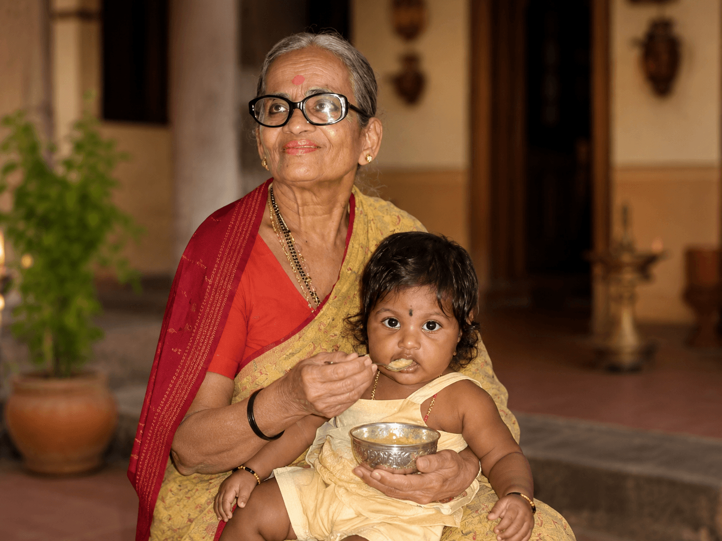 Grandmother feeding baby